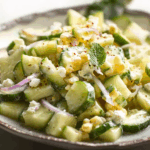 Corn and cucumber salad recipe in a rustic wooden bowl