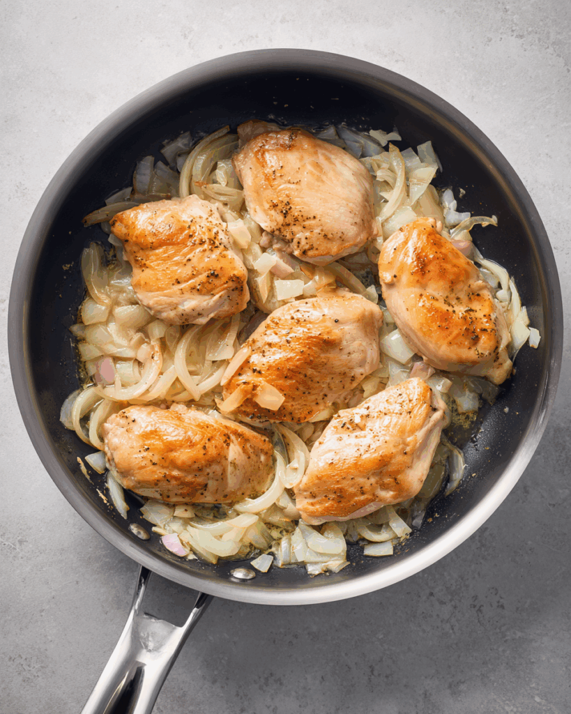 Coconut milk added to sautéed aromatics for Coconut Milk Chicken