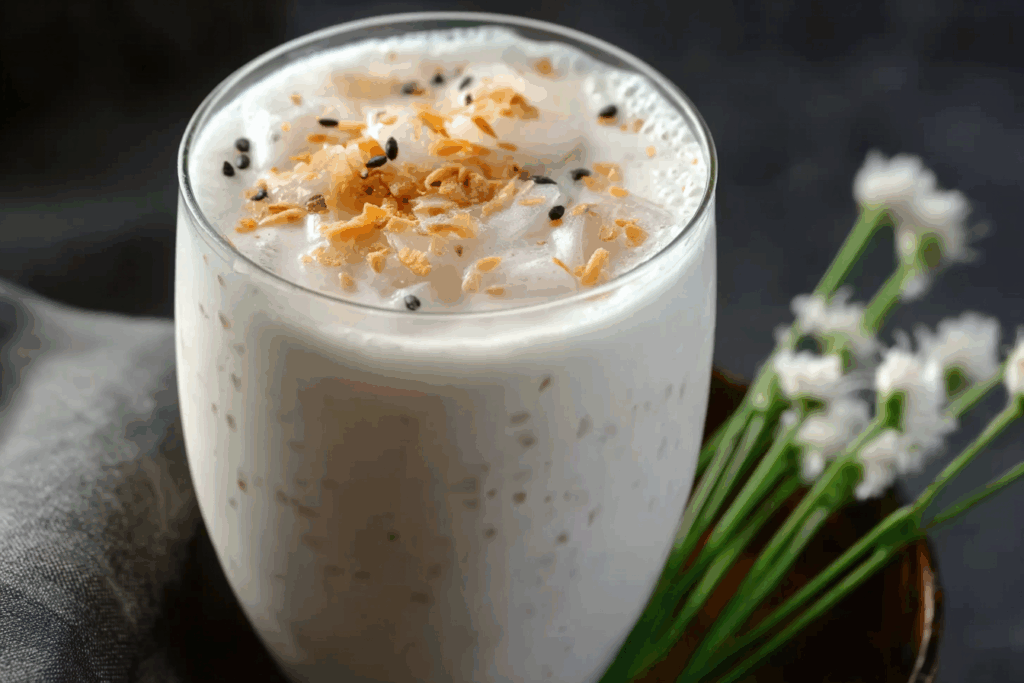Thai coconut shake with toasted coconut flakes and mint sprig