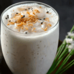 Thai coconut shake with toasted coconut flakes and mint sprig