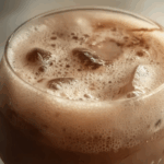 Thai Iced Cocoa Milk in a glass with ice and chocolate swirls