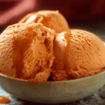 creamy Thai tea ice cream in a coconut bowl