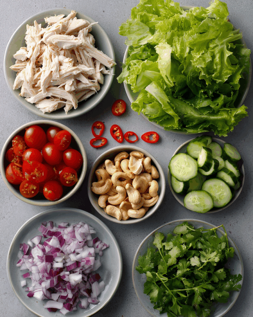 Tossing Thai Chicken Salad with fresh ingredients