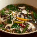 Thai Mushroom Soup with Herbs in traditional Thai bowl