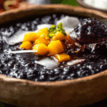 Thai Black Sticky Rice Pudding served with coconut cream and mango