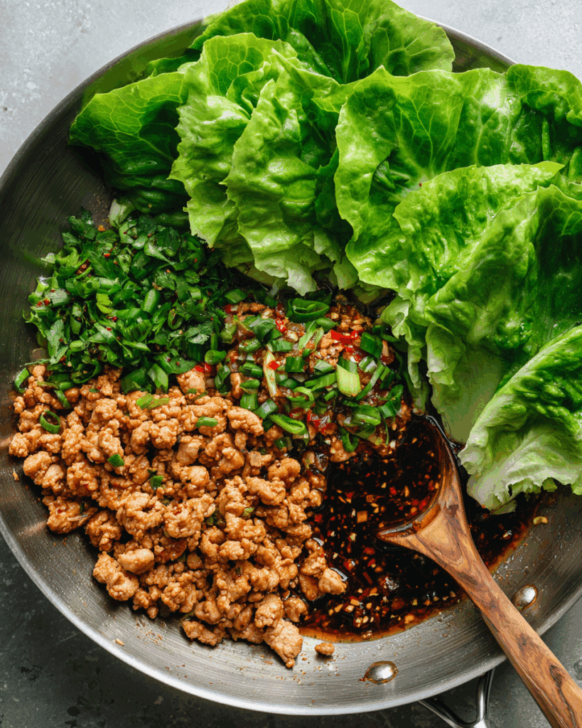 Cooking the chicken filling for Thai Chicken Lettuce Wraps in a skillet.