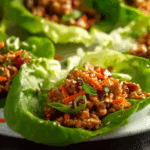 Thai Chicken Lettuce Wraps served fresh with sesame seeds and lime.