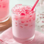 Thai pink milk drink in clear glass with crushed ice and evaporated milk