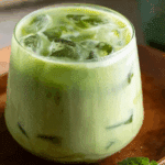 Thai Iced Coconut Matcha Latte served in a tall glass with layered colors.
