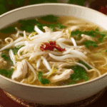 Thai Clear Soup with Bean Sprouts and Chicken served in a rustic bowl