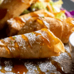 Thai Banana Spring Rolls with Honey Drizzle served on a plate.