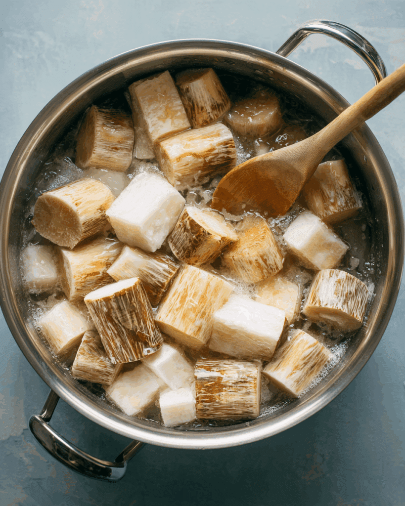 Taro cubes simmering in coconut milk with pandan leaves