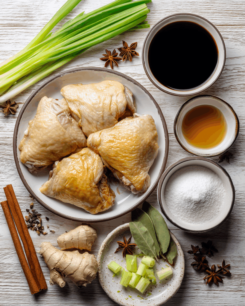 Ingredients for Thai Braised Chicken with Soy Sauce including chicken thighs, soy sauce, and spices.