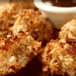Thai Coconut and Cocoa Macaroons on a plate with coconut flakes and lime