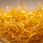 Golden Egg Threads Thai dessert plated with pandan leaf