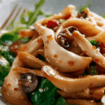 King Oyster Mushroom Salad served with sesame and chili.