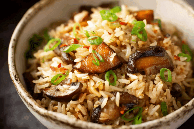 Delicious baked mushroom rice served in a ceramic dish with golden mushrooms and herbs.