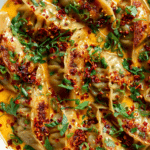 Baked dumplings in Thai red curry sauce freshly garnished and ready to serve
