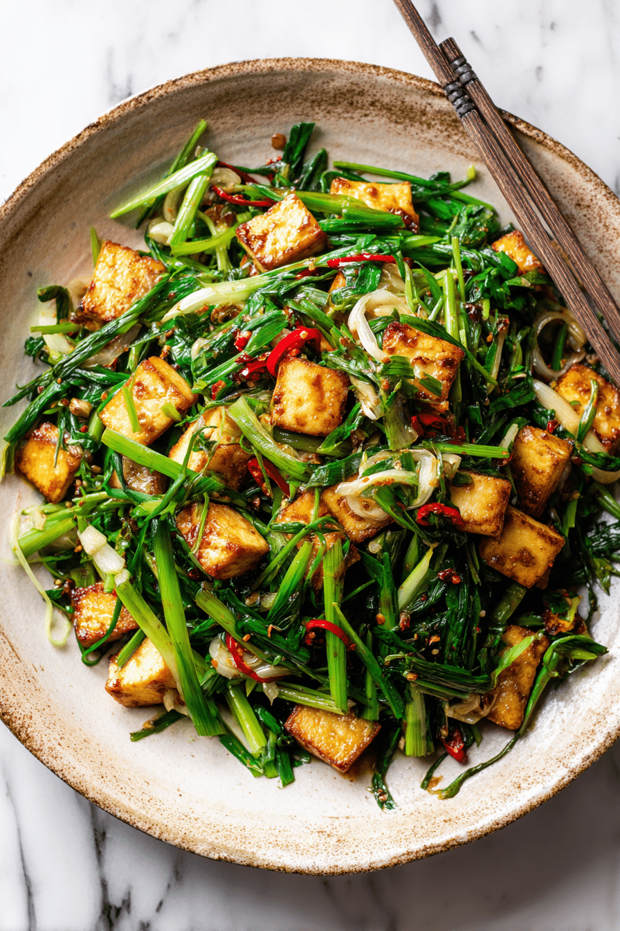 Garlic Chives Recipe with Tofu served in a bowl with rice.