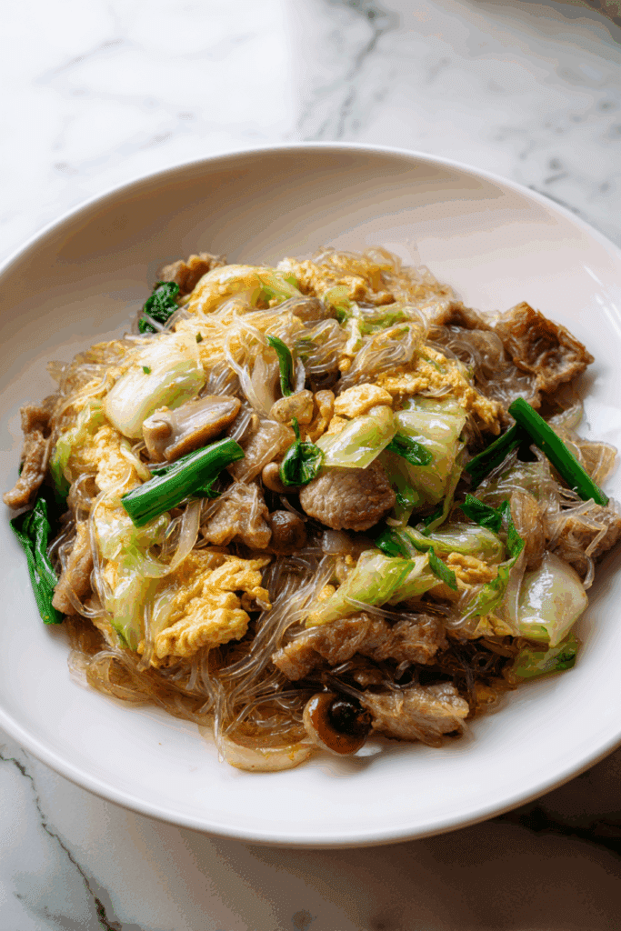 Delicious bowl of Suki Dry Noodles with beef, egg, and vegetables.