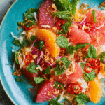 Authentic Thai Pomelo Salad served in a bowl with shrimp and herbs