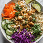Thai Chicken and Quinoa Bowl with Roasted Vegetables in natural light