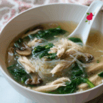 Thai Clear Soup with Bean Sprouts and Chicken served in a rustic bowl
