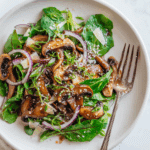 Warm mushroom salad with sesame dressing served beautifully