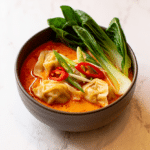Thai Red Curry Wonton Soup Recipe in a bowl with creamy coconut broth and tender wontons