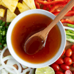 Homemade sweet and sour sauce for stir fry in a bowl with glossy texture