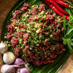 Thai Raw Beef Salad Recipe served in traditional Isan style with fresh herbs
